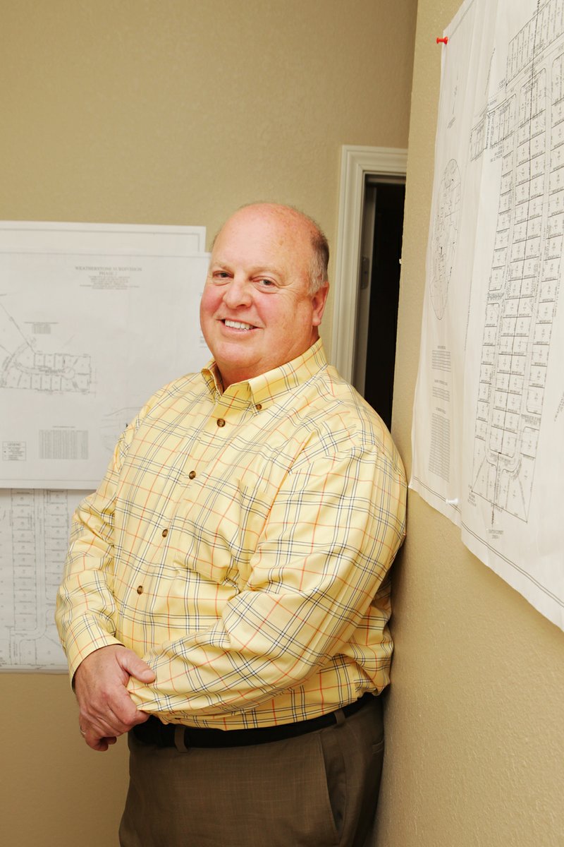 Hal Crafton looks over plans in his office at Rush-Hal Properties in Conway. Crafton’s love for the city is legendary among his friends and family. His business partner, Rush Harding III, said that when Crafton had a heart attack a few years ago in another town and was being airlifted, Crafton said, “If I’m going to die, I want to die in Conway,” and insisted on being taken to Conway Regional Medical Center instead of Little Rock.