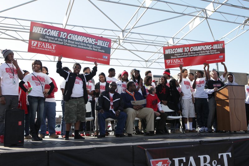 First Arkansas Bank & Trust revealed a design for a new billboard Wednesday that will honor the Jacksonville High School boys and girls basketball teams for winning state championships. Copies of the billboard were shown after a parade honoring the teams was held in downtown Jacksonville.