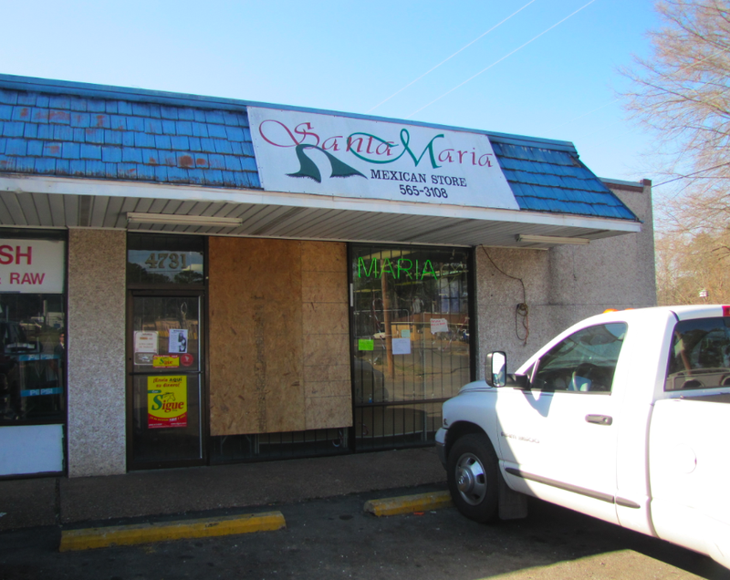 Boards cover windows shattered by gunfire at the Santa Maria Mexican Store on Base Line Road Friday.