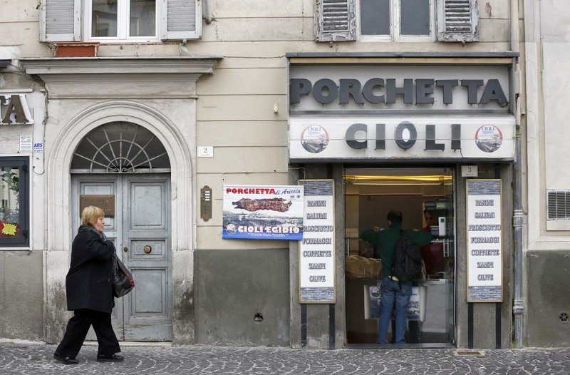 A pedestrian passes a porchetta meat shop in Ariccia, Italy, which typically offers a spit-roasted pork. Europe’s politicians are trying to temper austerity programs that have slowed growth and made it harder for governments to control their deficits. 