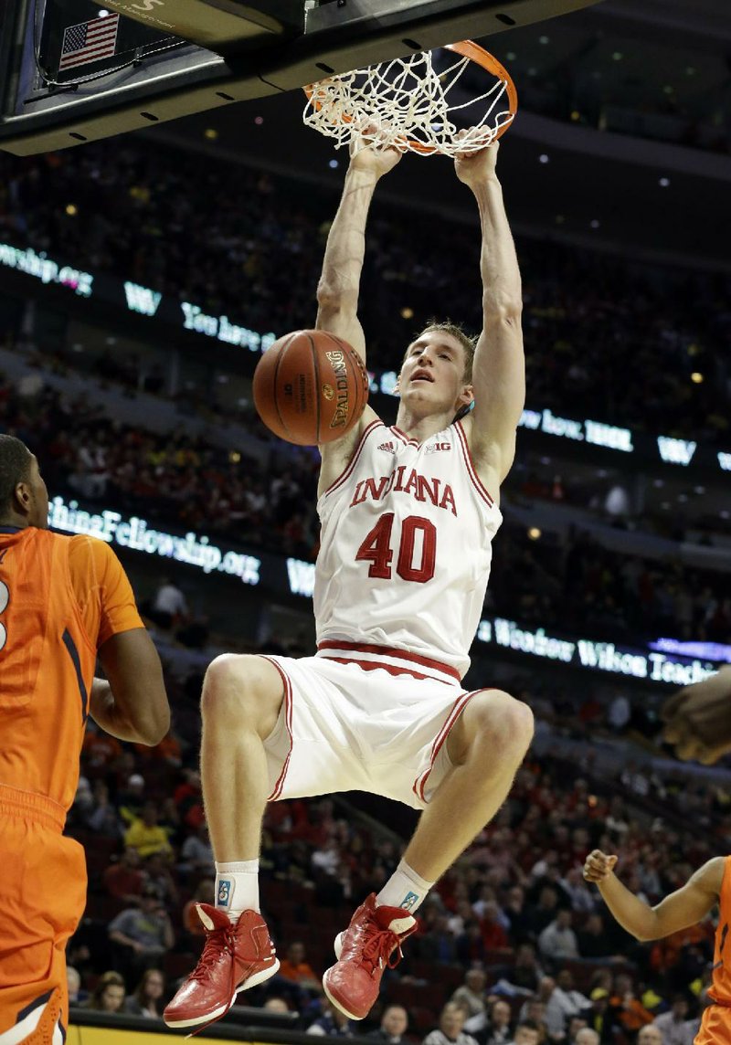 Indiana’s Cody Zeller (40) dunks the ball as an Illinois defender watches during the second half of the Hoosiers’ 80-64 victory over the Fighting Illini on Friday in the quarterfi nals of the Big Ten tournament at the United Center in Chicago. 