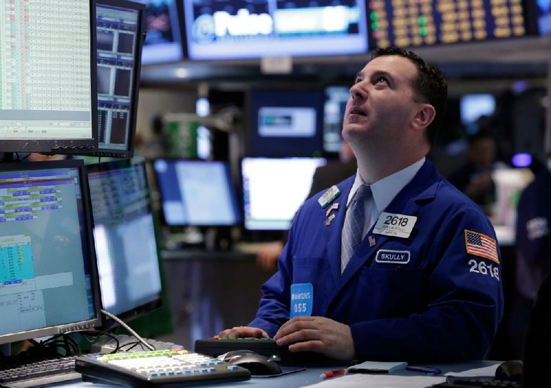 Specialist James Sciulli works Friday at his post on the New York Stock Exchange. 