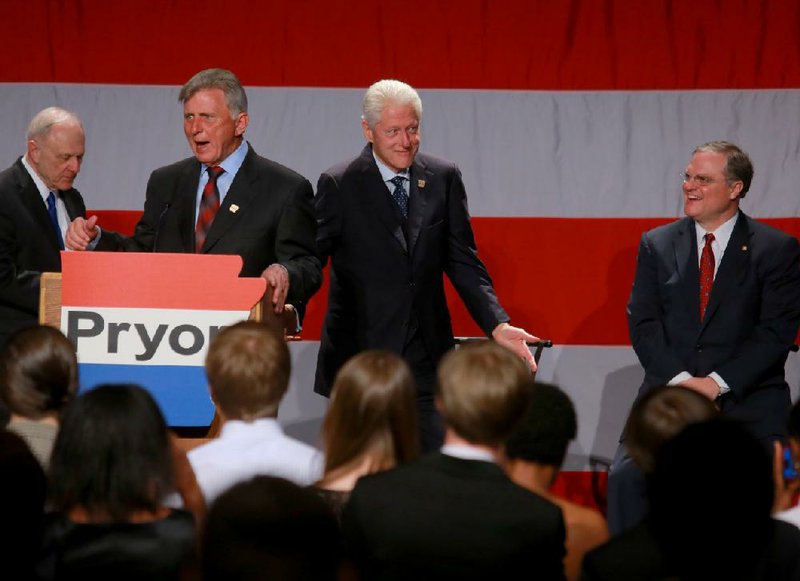 Former President Bill Clinton, center, reacts to a joke from Gov. Mike Beebe, second from left, during a fundraising event for US Senator Mark Pryor, right, also attended by his father Former US Senator David Pryor, left, Saturday evening in Little Rock.