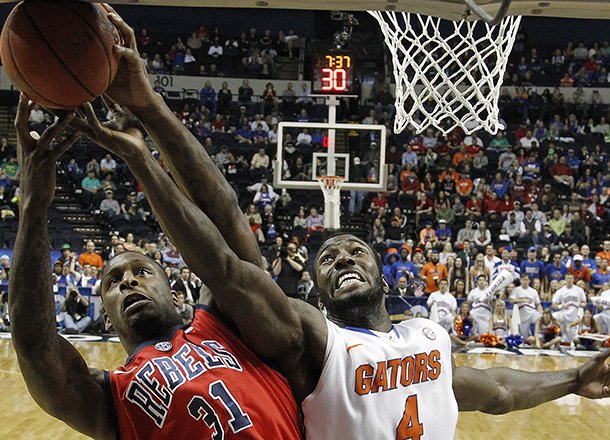 Florida center Patric Young (4) vies for a rebound with Mississippi forward Murphy Holloway (31) during the first half of an NCAA college basketball game in the final round of the Southeastern Conference tournament, Sunday, March 17, 2013, in Nashville, Tenn. (AP Photo/John Bazemore)