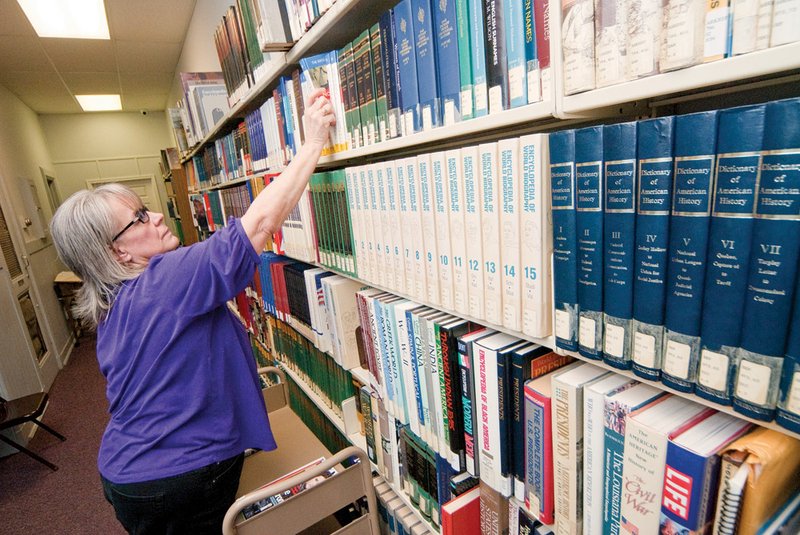 Cleburne County Library employee Sharon Shafer shelves a book at the after a recent move to the former district court building. The library’s temporary home is at 102 E. Main St.