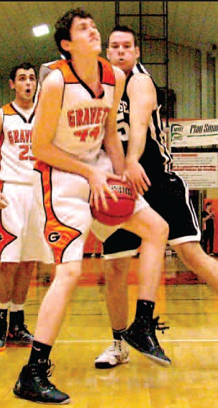 Gravette junior, Otto Troutner, grabs a rebound away from Pea Ridge forward Isaac Mangrum during play in Gravette in play this past season. 