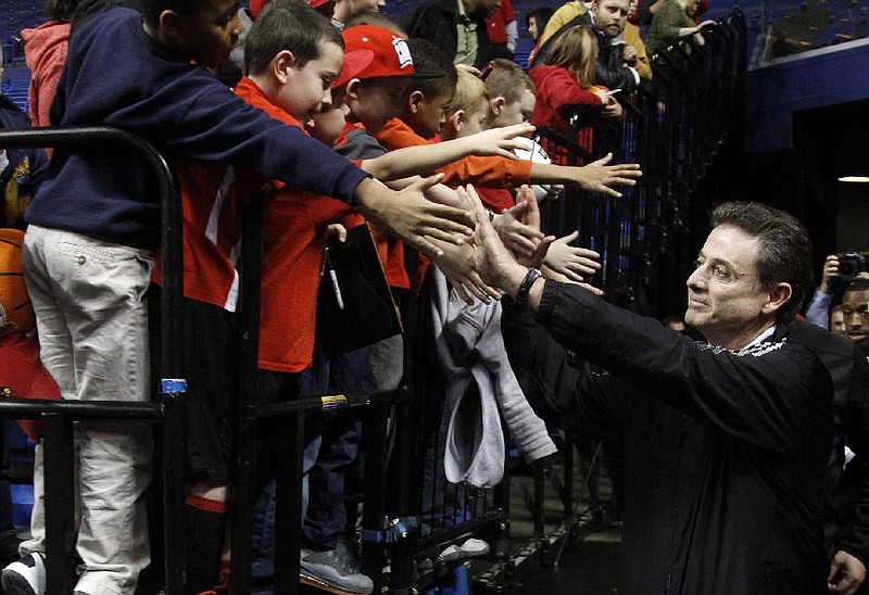 Louisville head coach Rick Pition greets fans as he arrives to a practice for a second-round NCAA college basketball tournament game on Wednesday, March 20, 2013, in Lexington, Ky. Louisville will play North Carolina A&T on Thursday. (AP Photo/James Crisp)  