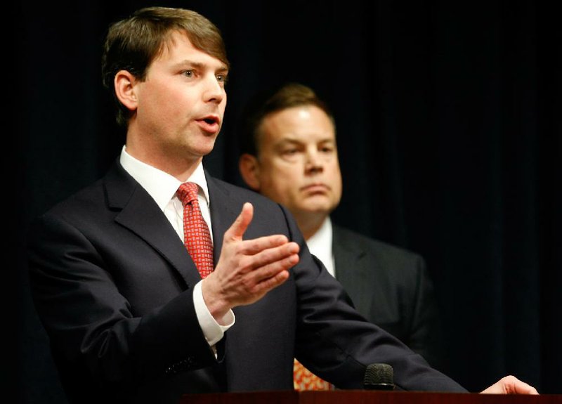 NWA Media/JASON IVESTER
Randall Coleman (right), FBI Special Agent in Charge, listens as Conner Eldridge, U.S. Attorney for the Western District of Arkansas, speaks during a news conference on Wednesday, March 20, 2013, inside the U.S. Attorney's Office in Fort Smith. Eldridge announced charges with federal crimes for Brandon Barber, Vaughn Knight, James Van Doren, Jeff Whorton and Brandon Rains. Barber was arrested earlier in the day in New York.