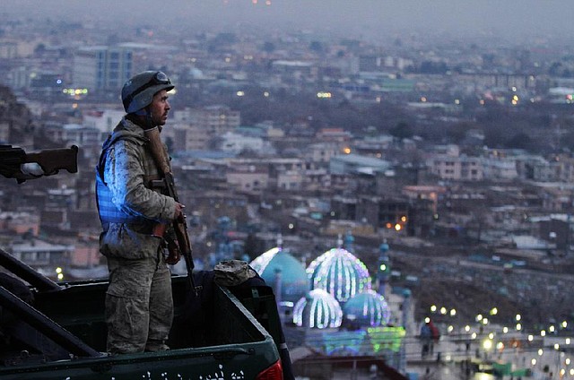 An Afghan Army soldier secures the hill overlooking the Kart-e Sakhi mosque in Kabul, Afghanistan, Wednesday, March 20, 2013. Thousands of Afghans will celebrate Nowruz on Thursday, March 21, 2013 to mark the first day of spring and the beginning of the year on the Iranian calendar. (AP Photo/Ahmad Jamshid)