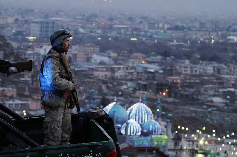 An Afghan Army soldier secures the hill overlooking the Kart-e Sakhi mosque in Kabul, Afghanistan, Wednesday, March 20, 2013. Thousands of Afghans will celebrate Nowruz on Thursday, March 21, 2013 to mark the first day of spring and the beginning of the year on the Iranian calendar. (AP Photo/Ahmad Jamshid)