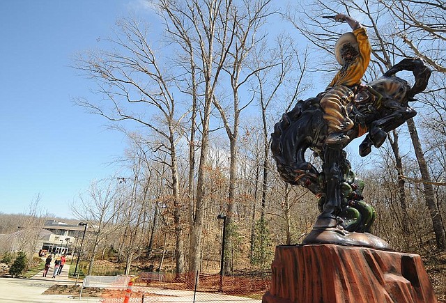 STAFF PHOTO MARC F. HENNING
"Vaquero," a 16-foot-tall polychrome fiberglass sculpture by Luis Jimenez, stands on the Crystal Bridges Art Trail in Bentonville. The sculpture is a permanent part of Crystal Bridges Museum of American Art's collection.