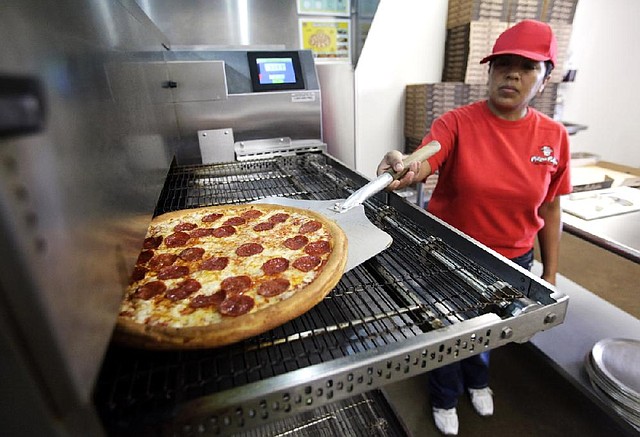 Employee Rosy Tirado pulls a pepperoni pizza from an oven at a Pizza Patron Dallas, Texas. While lower-wage American workers have accounted for the lion's share of the jobs created since the 2007-2009 Great Recession, a survey released March 2013 shows that they are also among the most pessimistic about their future career prospects, their job security and their finances. 