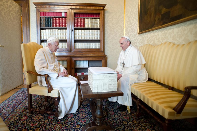 In this photo provided by the Vatican paper L'Osservatore Romano, Pope Francis, right, and Pope emeritus Benedict XVI meet in Castel Gandolfo Saturday, March 23, 2013. Pope Francis has traveled to Castel Gandolfo to have lunch with his predecessor Benedict XVI in a historic and potentially problematic melding of the papacies that has never before confronted the Catholic Church.