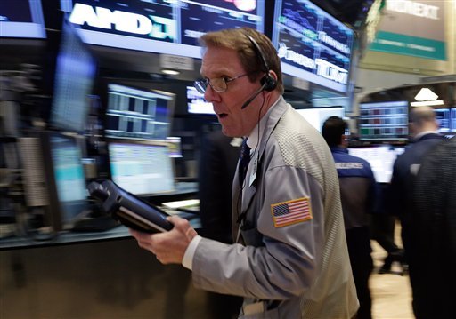 Trader Luke Scanlon rushes across the floor of the New York Stock Exchange Monday, March 25, 2013. U.S. stock markets are opening higher after Cyprus clinched a last-minute bailout that saved it from bankruptcy. 