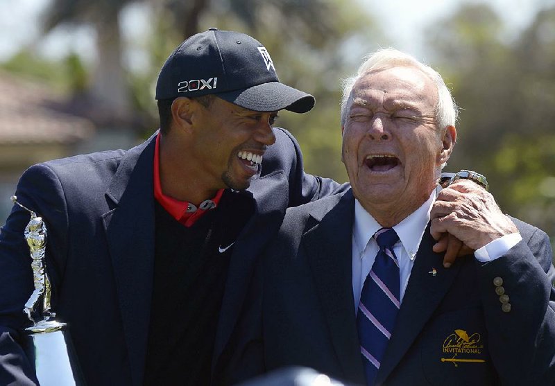 Tiger Woods (left) speaks with Arnold Palmer during the trophy presentation after Woods won the Arnold Palmer Invitational in Orlando, Fla., on Monday afternoon. Woods earned his 77th PGA Tour victory and 99th professional victory. 