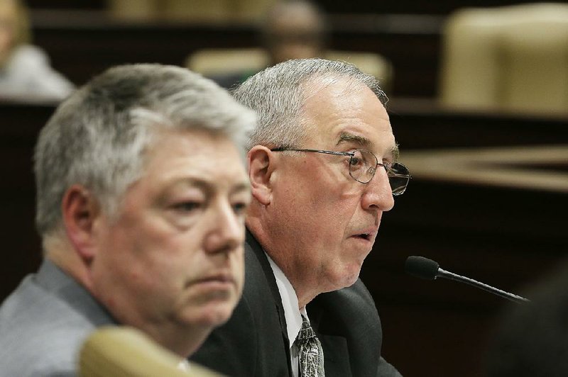 Consultant Phil Hopkins (right) of IHS Global Insight Steel Service speaks on a proposed Arkansas steel mill during a meeting of the House and Senate Agriculture, Forestry and Economic Development committees at the state Capitol as IHS Director John Anton (left) listens Monday. 