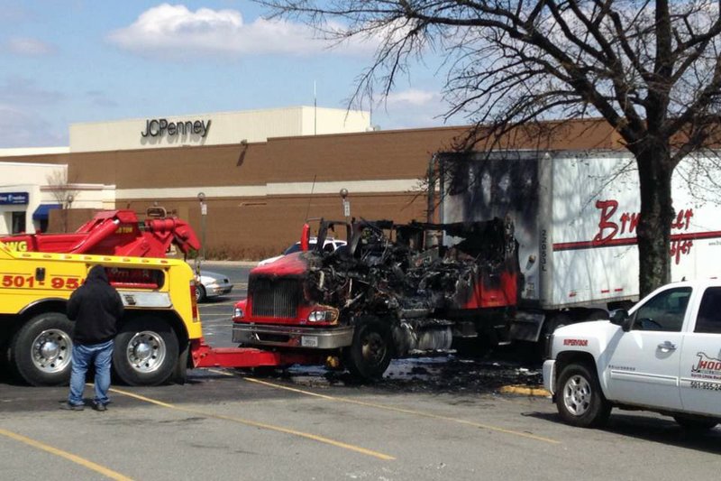 An 18-wheeler is towed from the parking lot of McCain Mall in North Little Rock after it caught fire early Monday afternoon. The cause of the fire was not immediately known, and no injuries were reported.