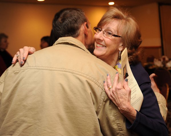 Carol Hart, right, receives a hug from one of her sons, Jacob Hart of Springdale, during the 15th annual Washington County Women in History Banquet on Monday at the GuestHouse International Inn in Fayetteville. The event honors women who made significant contributions to Washington County. In 1976, Hart founded Life Styles Inc., which assists with securing independence for adults with disabilities. 