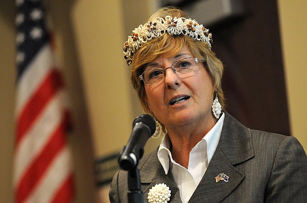 Martha Campbell, former U.S. ambassador to the Marshall Islands, wears a traditional Marshallese “wut,” or headband, while speaking Tuesday about the history and relationship between the U.S. and the Micronesian nation at NorthWest Arkansas Community Collegein Bentonville. 