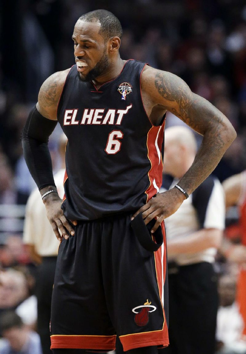 Miami Heat forward LeBron James pauses during the second half of the Heat's 101-97 loss to the Chicago Bulls in an NBA basketball game in Chicago on Wednesday, March 27, 2013. The loss ended the Heat's 27-game winning streak. (AP Photo/Nam Y. Huh)