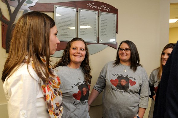 Jordan Curtis, from left, with Arkansas Regional Organ Recovery Agency, talks Wednesday with Trista Cravens, Jeri Williams and Nicki Pitts, after the unveiling of Washington Regional Medical Center’s Organ Donor Memorial Wall at the Fayetteville hospital in Fayetteville. The wall features the names of people who have donated organs at the hospital. Curtis is the in-house organ coordinator at Washington Regional, and the other three are the sisters and mother of Trenton Williams who donated his organs after his death. The event featured staff of the hospital, families of donors and recipients. 