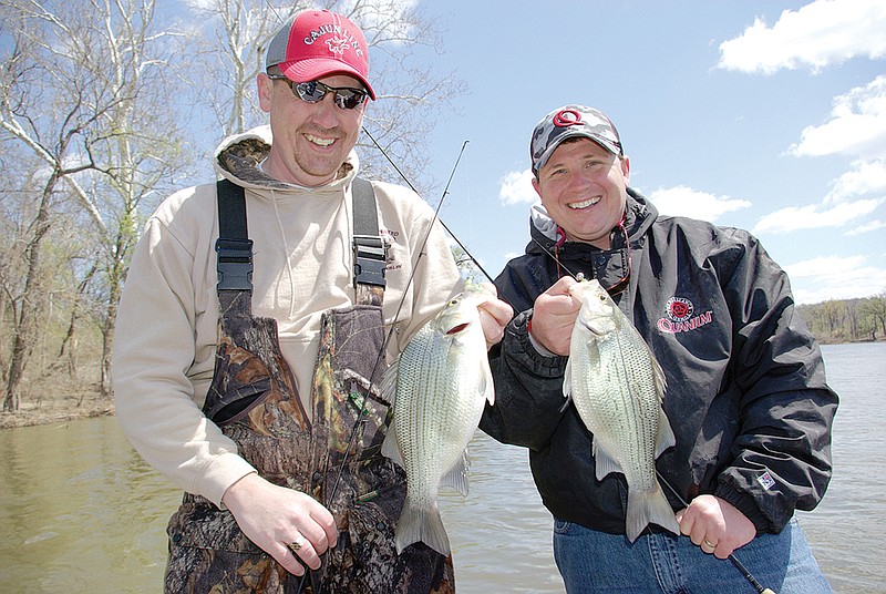 Josh Sutton, left, of Wynne and James Therrell of Tulsa, Okla., are all smiles after catching this pair of nice white bass. During the spring spawning season, double hookups are common. 
