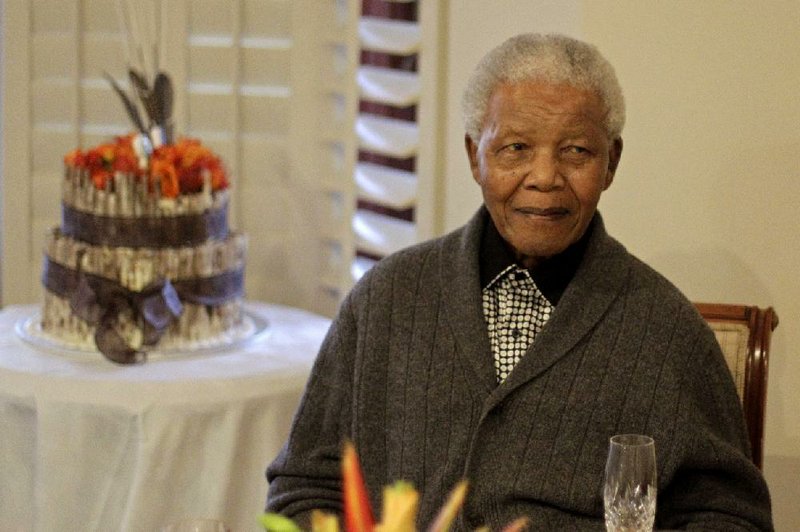 FILE - In this Wednesday, July 18, 2012 file photo former South African President Nelson Mandela as he celebrates his birthday with family in Qunu, South Africa, Wednesday, July 18, 2012. (AP Photo/Schalk van Zuydam)
