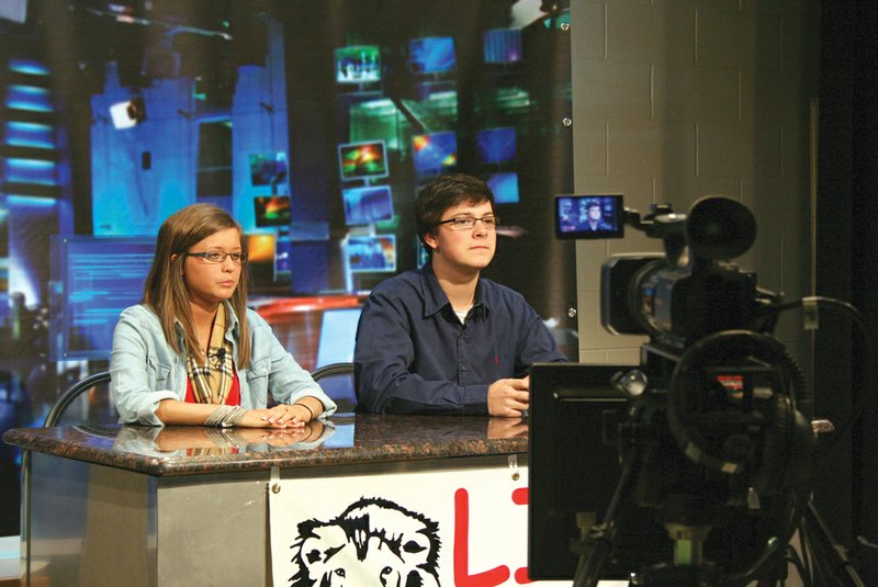 Searcy High School juniors Lacey Hall and Dylan Rohr prepare to tape a newscast for Lion TV.