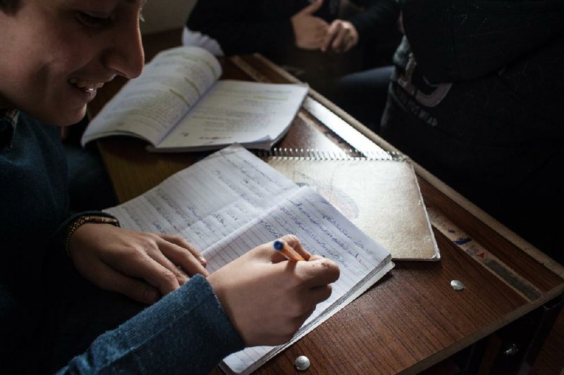 Salim, a Syrian refugee, works during class Feb. 7 at the Albashayer School in Antakya, Turkey, one of the few places for Syrian teenagers to continue their education in Turkey. The school is filled and has a waiting list. Illustrates SYRIA-SCHOOL (category i), by Jenna Johnson, (c) The Washington Post.  Moved Thursday, Feb. 14, 2013. (MUST CREDIT: Photo by Bradley Secker for The Washington Post).