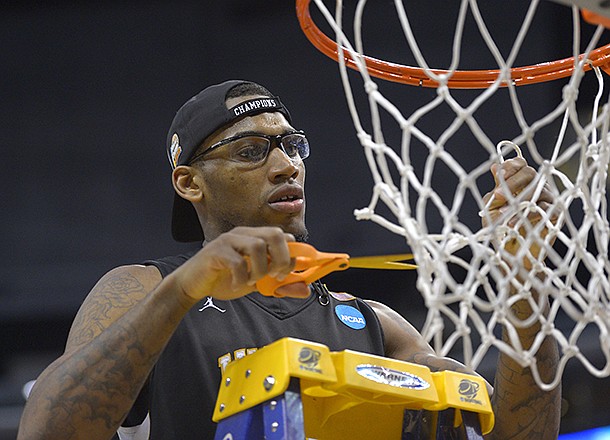 Wichita State forward Carl Hall celebrates by cutting down the net after defeating Ohio State 70-66 in a West Regional final in the NCAA college basketball tournament, Saturday, March 30, 2013, in Los Angeles. (AP Photo/Mark J. Terrill)