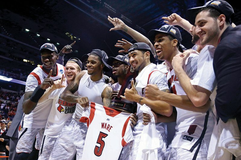 Louisville players celebrate following their 85-63 victory over Duke in the Midwest Regional final Sunday at Lucas Oil Stadium in Indianapolis. The Cardinals will play in their second consecutive Final Four under Coach Rick Pitino. 
