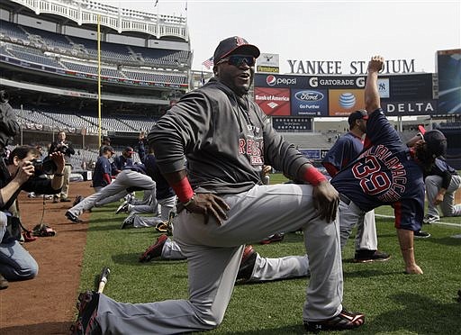 Boston Red Sox designated hitter David Ortiz (34) jokes with reporters on the field before the Red Sox Opening Day baseball game against the New York Yankees at Yankee Stadium in New York on Monday.