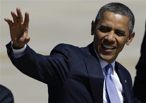 President Barack Obama waves as he walks to his limousine after his arrival at Buckley Air Force Base, Colo., Wednesday, April 4, 2013. The President traveled to Colorado to meet with local law enforcement officials and community leaders to discuss the new measures the state recently put in place, including closing loopholes in the gun ownership background check system. 