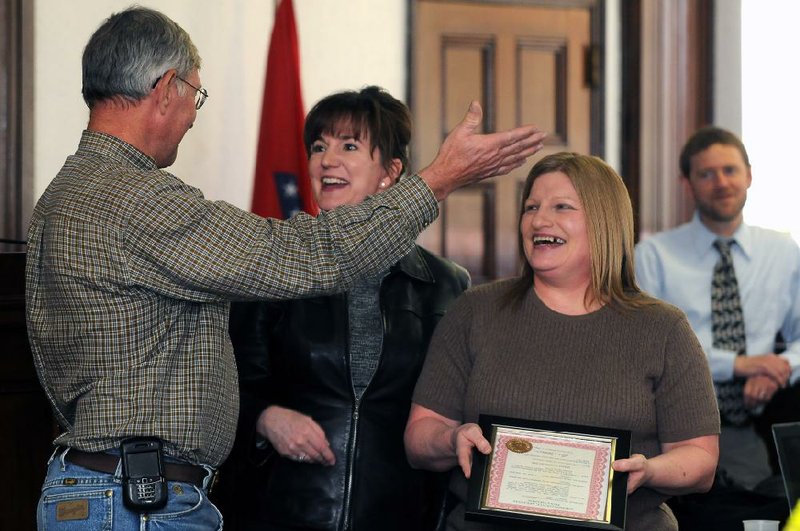 NWA MEDIA/SAMANTHA BAKER
Donna Goodnight, from right, and Judge Stacey Zimmerman laugh as Judge Frank Weaver declares Friday, March 29, 2013, as Donna Goodnight Day at the Madison County courthouse in Huntsville. Goodnight was celebrating her retirement from working for Madison County for 29 years. She began working with the sheriff's office in the jail and dispatch before becoming a juvenile probation officer in 1999.