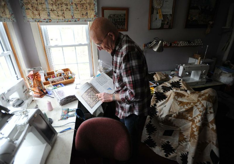 NWA Media/ANDY SHUPE
Jerry Patnoe of Elkins, a retired University of Arkansas professor of criminal justice, explains the process he uses to design quilts Wednesday, April 3, 2013, in the workroom in his home in Elkins. Patnoe was diagnosed with Parkinson's Disease in 2007, but continues to make quilts. One of his designs was selected for the 2013 Creativity and Parkinson's Calendar by the Parkinson's Disease Foundation.