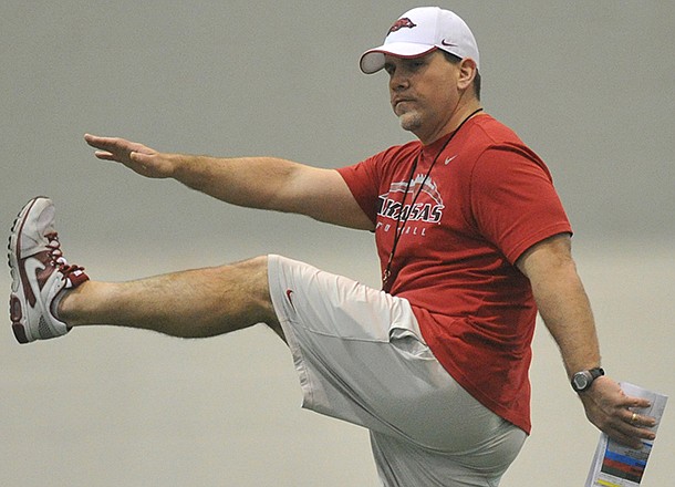 Arkansas assistant Charlie Partridge works with the Razorbacks during practice Saturday morning in Fayetteville.