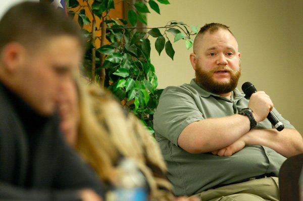 James Morphew, right, responds Wednesday to a question during a forum on gun control at NorthWest Arkansas Community College in Bentonville. The forum was a service learning project organized by students at the school. 