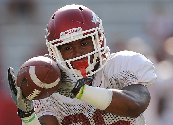 Arkansas safety Rohan Gaines catches a ball Saturday, Aug. 11, 2012, prior to the start of the Hogs' scrimmage in Razorback Stadium.