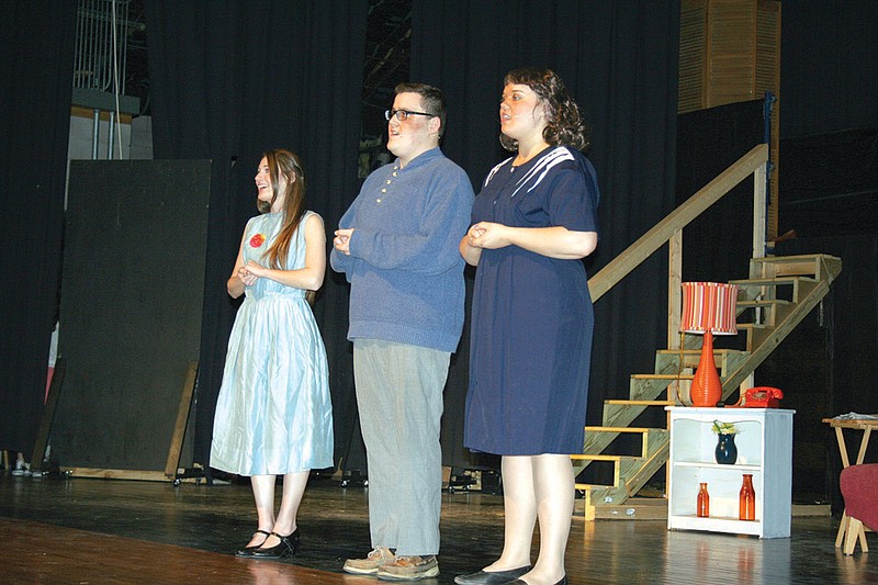 The McAfee family — Kim, played by Suzanne Atwell; Father, played by Frankie Pitts; and Lindsey Warner as Mother — sing a reverent tribute to Ed Sullivan in the Bryant High School production of Bye Bye Birdie. The cast will offer a public performance of the musical at 2 p.m. April 14.