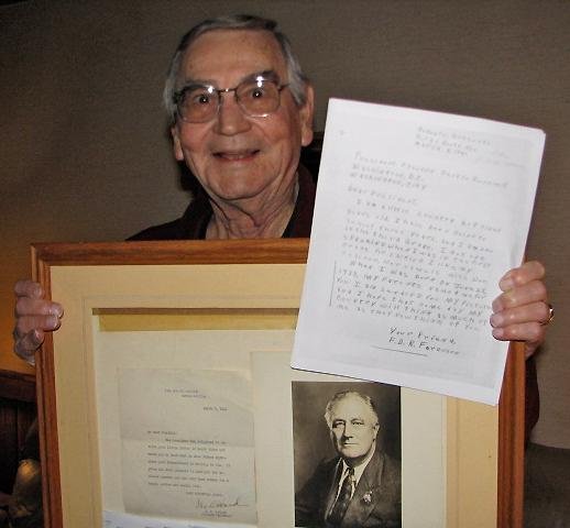 Forest Delano Roosevelt Ferguson holds a framed letter and photo he received from President Franklin Delano Roosevelt and a copy of the letter he sent to the president at age 8 in 1941. 