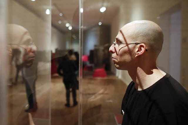 Ido Porat prepares to greet visitors at the Jewish Museum in Berlin. In a country with fewer than 200,000 Jews, museum officials hope the so-called “Jew in the Box” exhibition will educate visitors about Jewish life. 