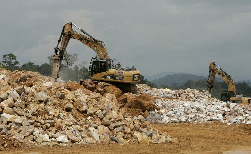 Caterpillar Inc. excavators stand at the G-Resources Group Ltd. Martabe gold and silver mine in Batang Toru in Indonesia, in February. Caterpillar said Friday that it plans to lay off more than 460 employees in Decatur, Ill. 