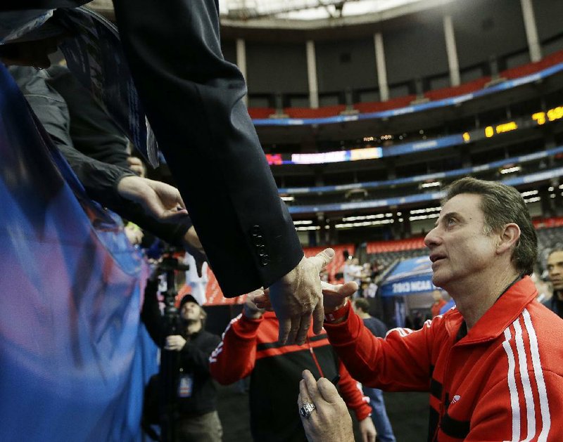 Louisville Coach Rick Pitino greets fans following Friday’s practice at the Georgia Dome in Atlanta. The Cardinals, the No. 1 overall seed in the NCAA Tournament, face No. 9 seed Wichita State today. 