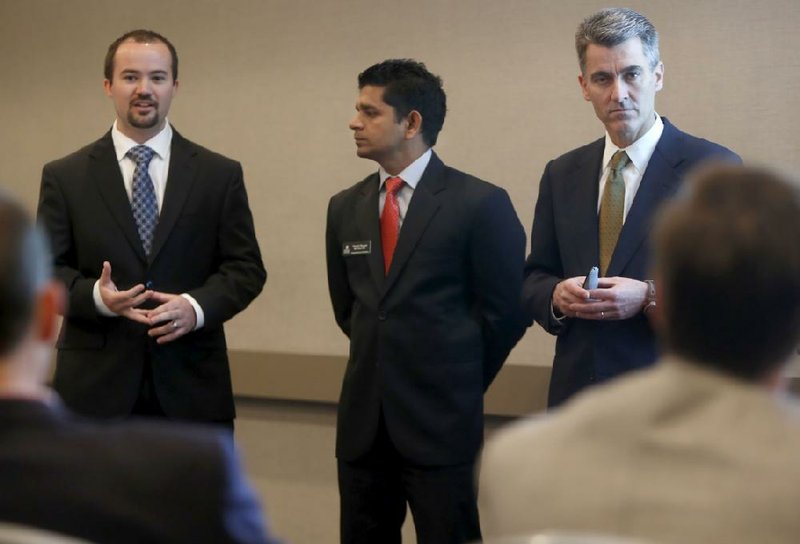 Corey Thompson, (from left) Manish Phogat and Bill Ryan, officers with EverClean Coating Solutions, speak to the judges Friday in the Donald W. Reynolds Governor’s Cup Collegiate Business Plan Competition in Fayetteville. 