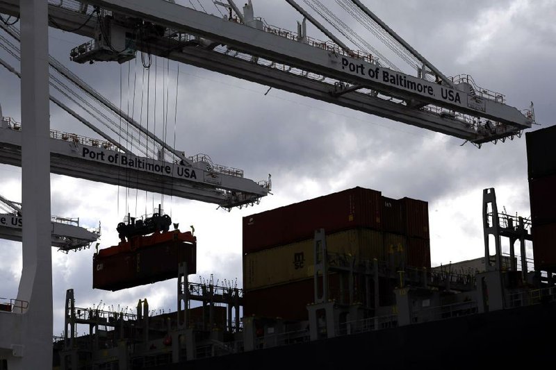 Work hums along at the Port of Baltimore’s Seagirt Marine Terminal. The U.S. trade deficit narrowed in February, the Commerce Department said Friday. 