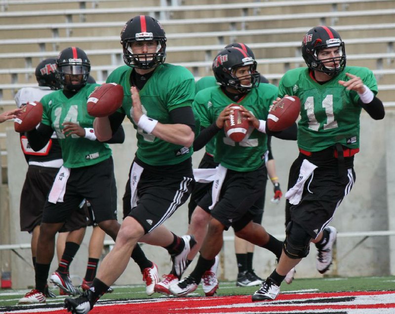 Dezmond Stegall (14), Stephen Hogan (8), Fredi Knighten (12) and Phillip Butterfield (11) are competing for the Arkansas State starting quarterback job this spring. 