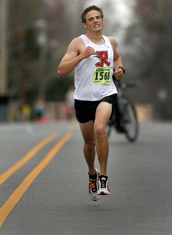 Tyler Surly makes his way south along N. Main Street on Saturday, April 6, 2013, to finish first in the Bentonville Half Marathon.