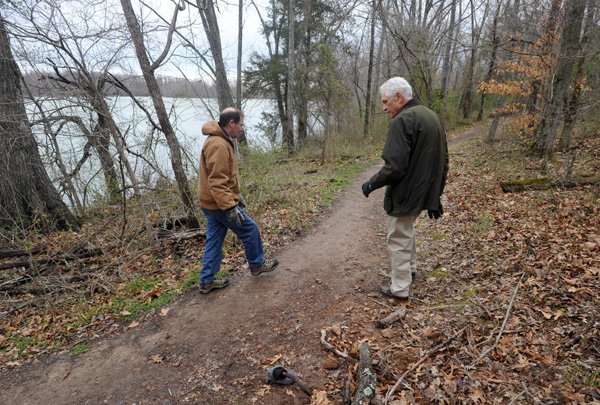 Walt Eilers, president of the Botanical Garden of the Ozarks Board of Directors, right, and Ron Cox, executive director of the Botanical Garden, walk along a section of the soft trail on the southeast side of Lake Fayetteville in an April file photo.