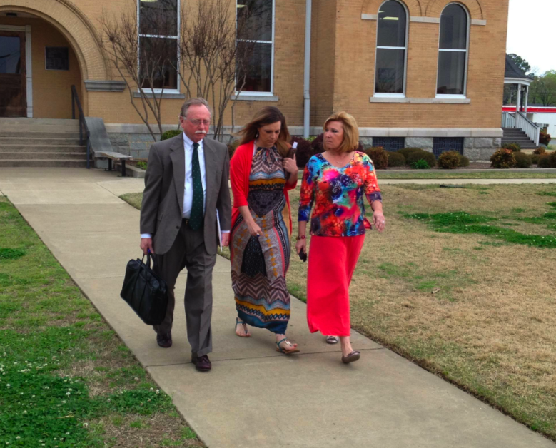 Courtney Speer, center, leaves Saline County Circuit Court Monday morning.