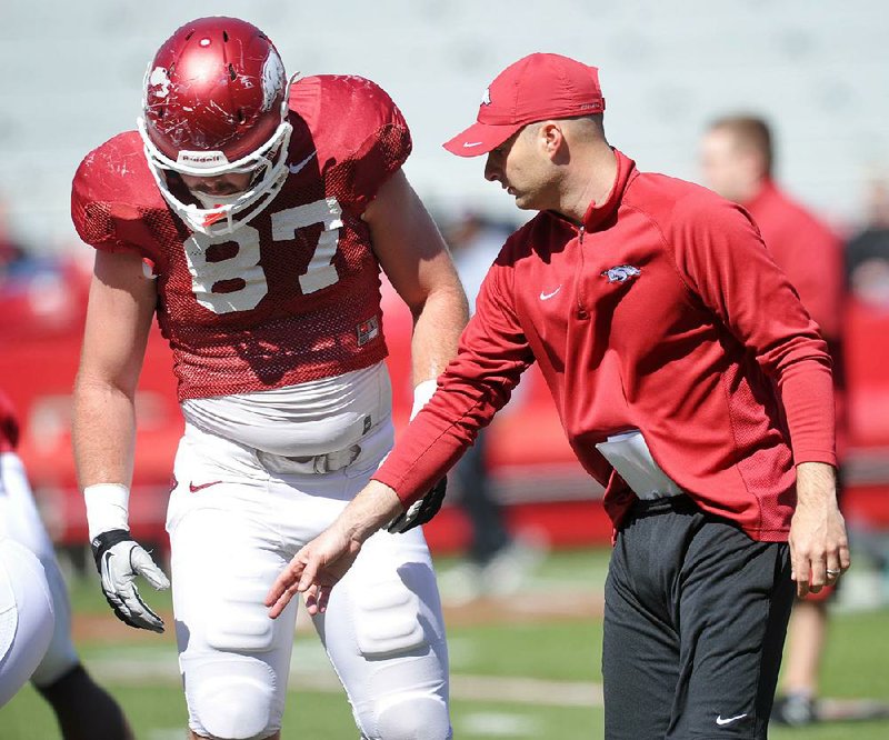 Arkansas tight ends coach Barry Lunney Jr. works with Austin Tate during an April 6, 2013 practice at Razorback Stadium in Fayetteville. 